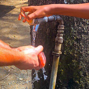 Black hand washing white hand