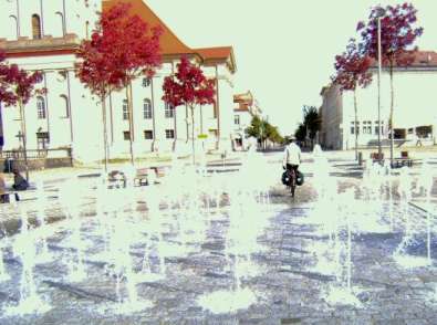 Sonja on the Bike zwischen den Wasserspielen auf dem Marktplatz von Neustrelitz, Mecklenburg