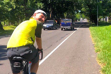 Cyclist looking back smiling in El Salvador