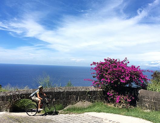 Miri on the Bike climbing Brimstone Hill Fortress, St. Kitts 